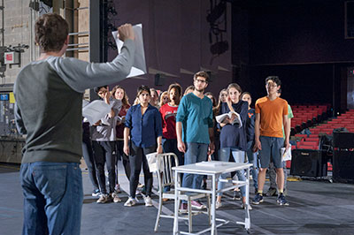 Cast members rehearsing a scene of UVA Department of Drama's production of URINETOWN. Photo by Michael Bailey.