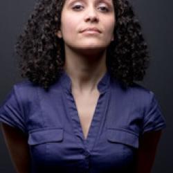 Woman, dark hair, dark v-neck blouse, facing the camera