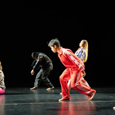 five dancers in colorful outfits in various poses