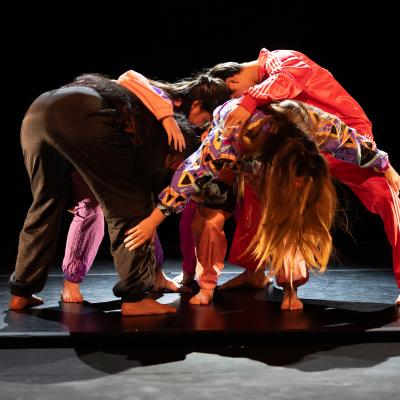 five dancers leaning together in a pile of sorts