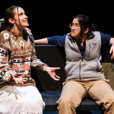 CAFE OF BABEL: Two actors sitting, in motion, arguing