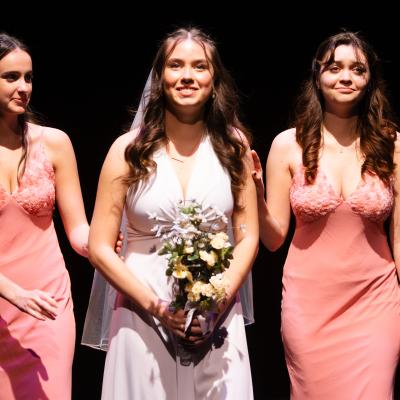 HATE MY SISTER: Bride flanked by two bridesmaids, smiling out at the audience.
